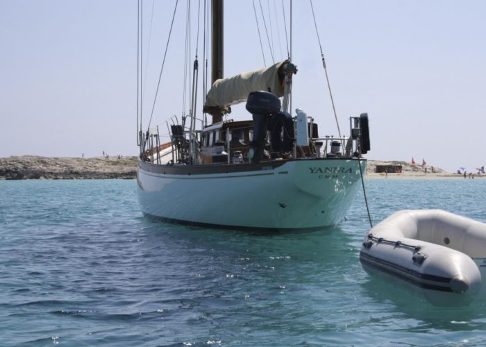 Classic sailing yacht Yanira towing dinghy