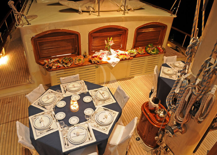 classic sailing yacht ofelia external deck night dining.jpg